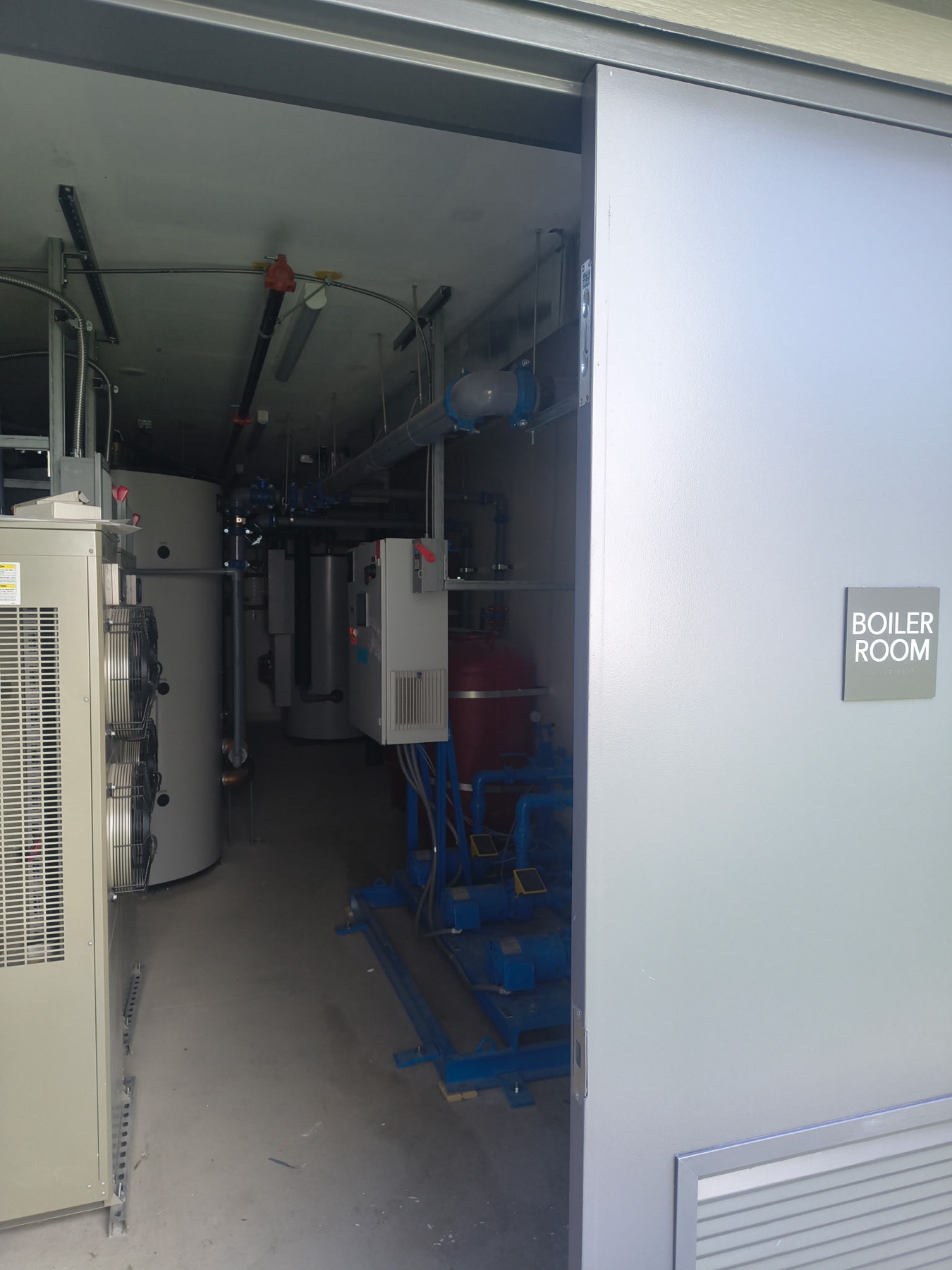 Boiler room equipment and electrical conduit in a multifamily building