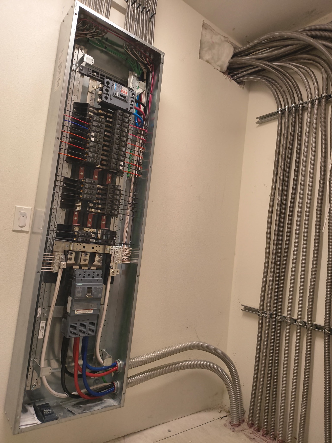Building main distribution panel with neatly installed metal conduit